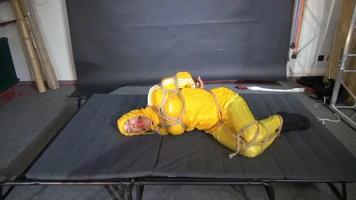 Shinynylonartsbound - Ms Ungeniert bound and gagged in a shiny nylon Rainsuit trying to get free