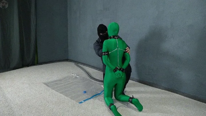 Vacuum Dreams - Bondage green zentai leather handcuffs in a vacuum bag