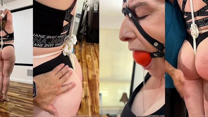 Aussie Bondage Girl - Stretched out onto her toes, her wrists tied over her head to the crotch rope, and pulled extra tight by the electric-hoist